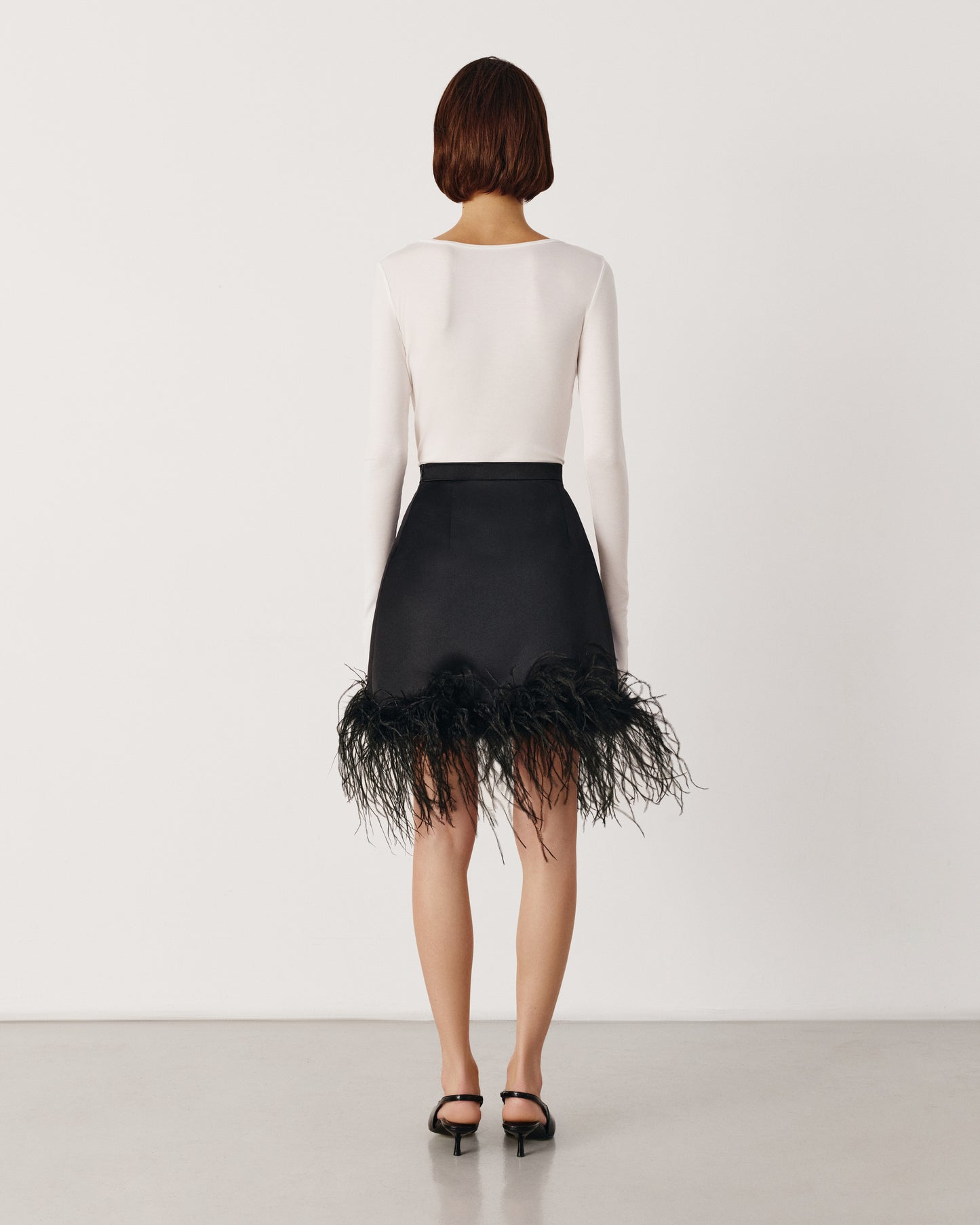 Black satin skirt with feathers