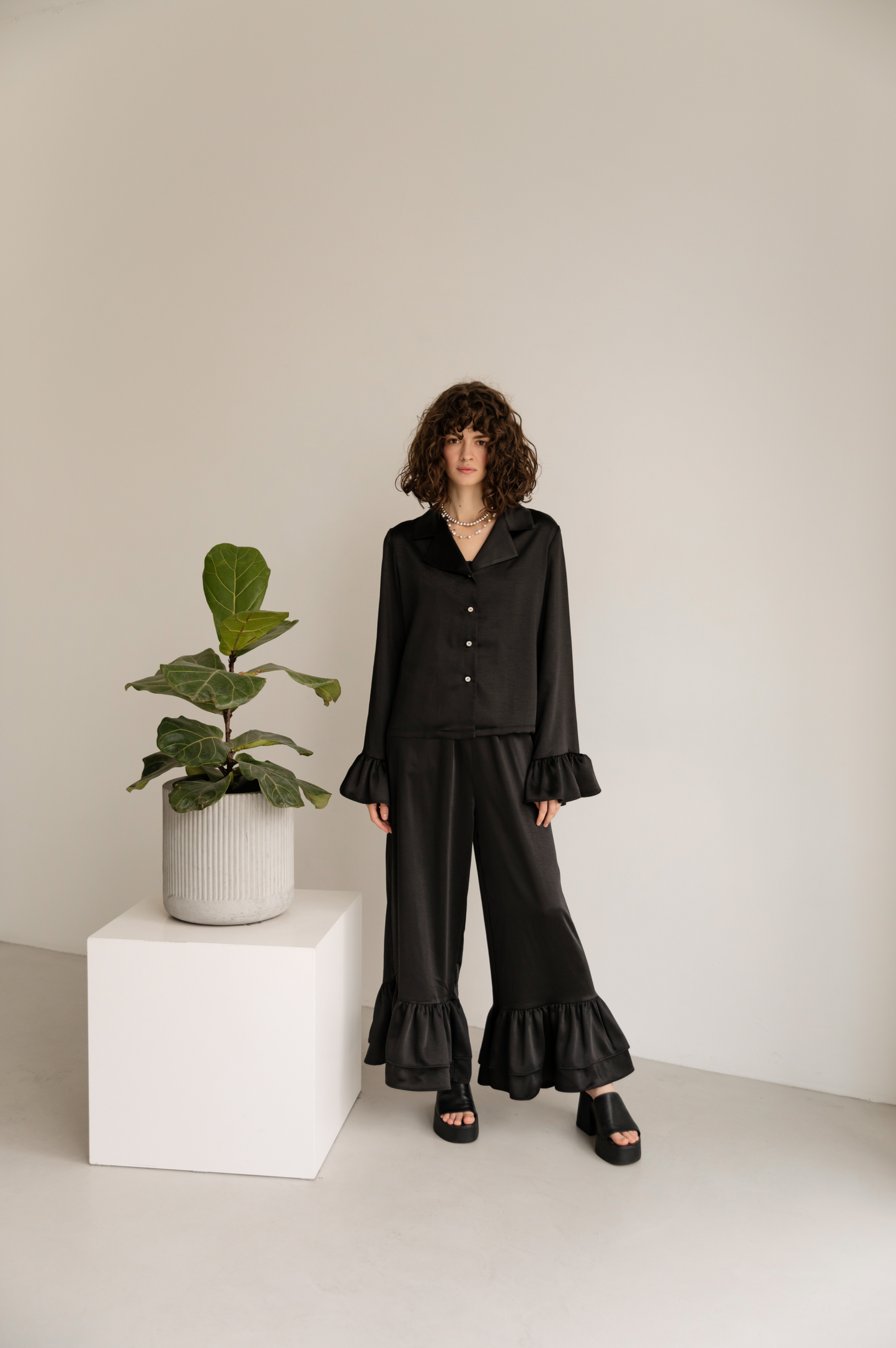 Black blouse with ruffles satin