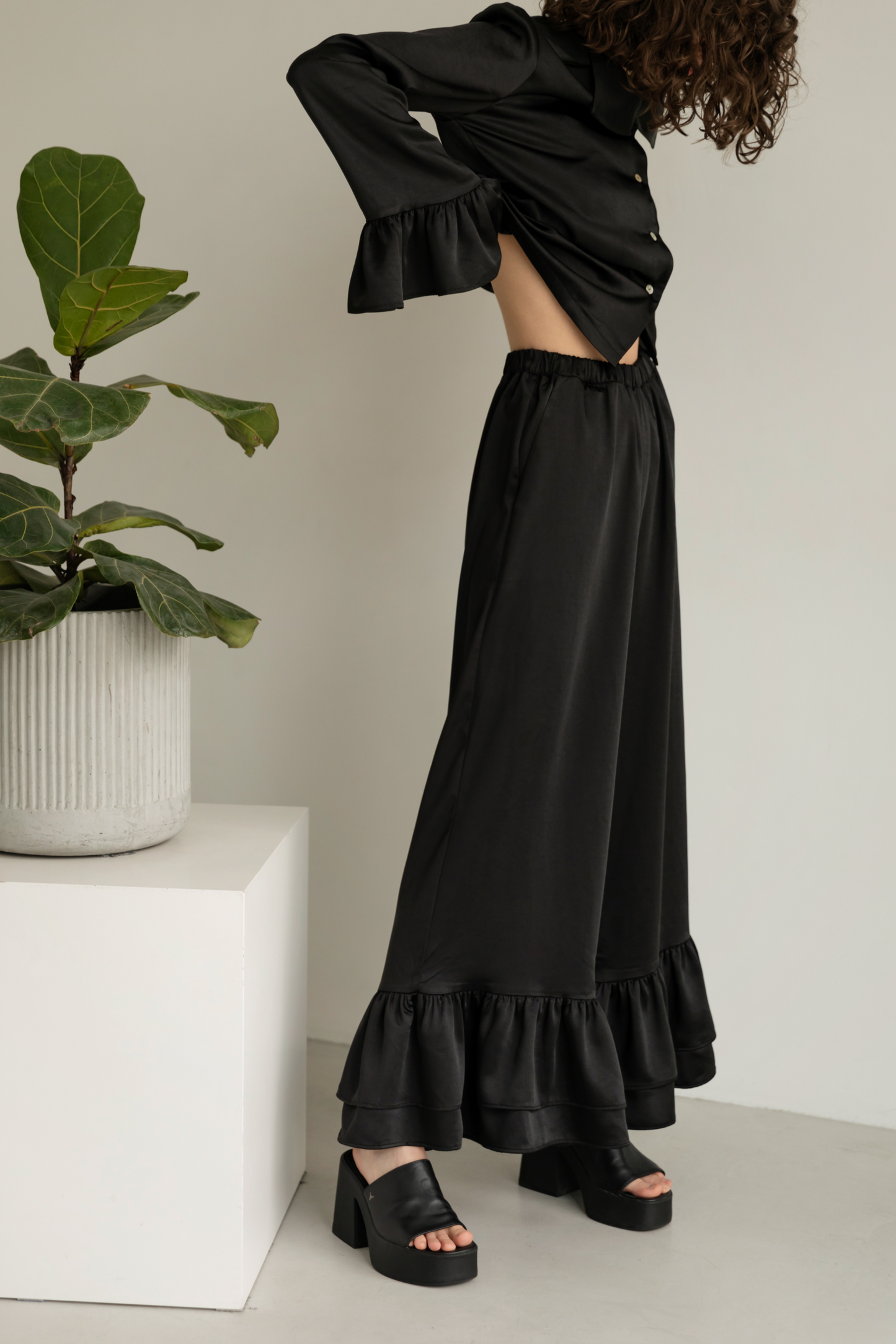 Black blouse with ruffles satin