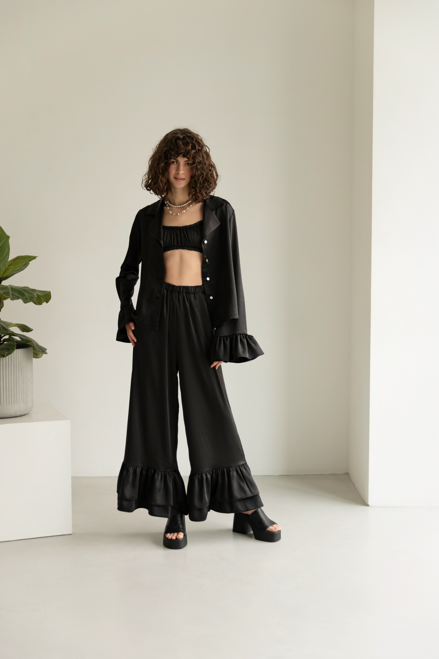 Black blouse with ruffles satin