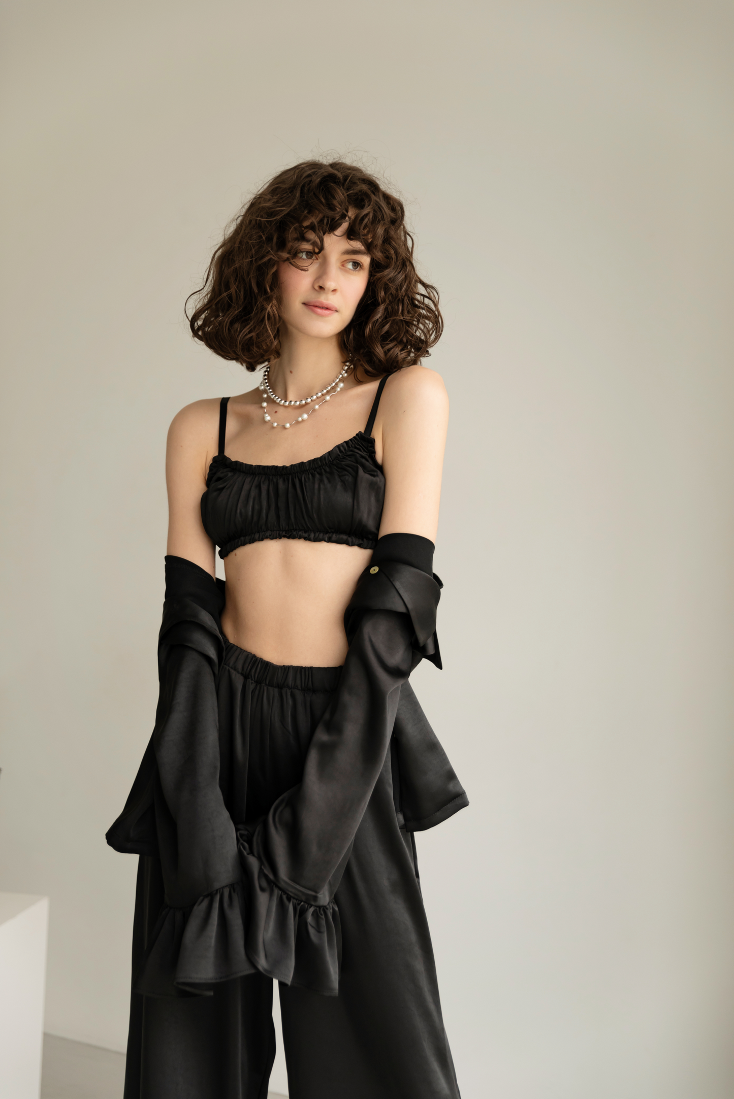 Black blouse with ruffles satin