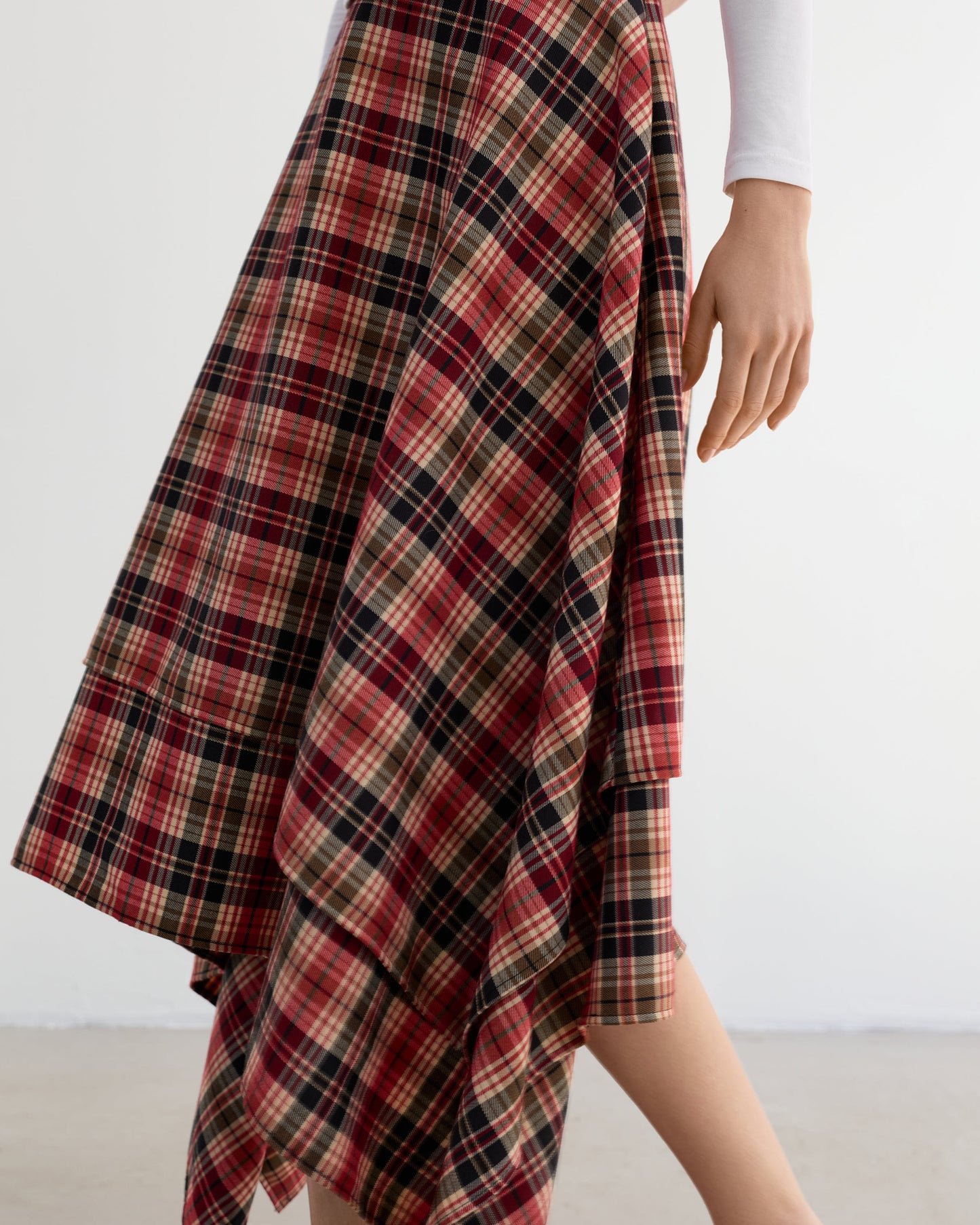 Asymmetric spring check skirt